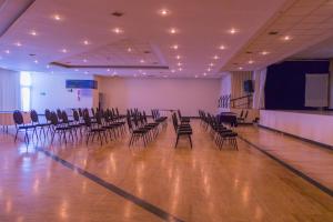 a large room with chairs and a stage with a screen at Hotel Calacoto in La Paz