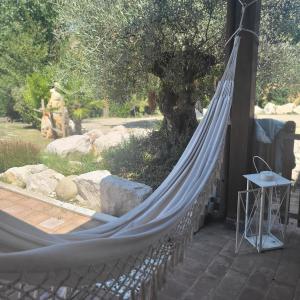 a hammock tied to a house with a tree at Villa Tilly in Trarivi