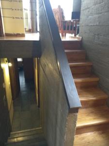 a stairway in a building with a metal railing at Altos del Alma Cabañas in San Martín de los Andes