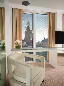a living room with a large window and a television at St Martins Lane London in London