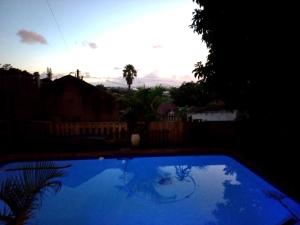 a large blue swimming pool in a yard at Anne's Cottage in Durban