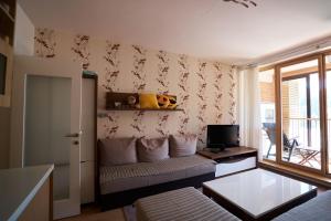 a living room with a couch and a tv at The Nest - harmony place to spend a mountain brake in Bjelašnica