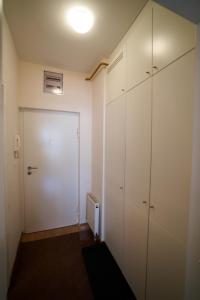 a room with white cabinets and a door at The Nest - harmony place to spend a mountain brake in Bjelašnica