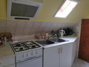 A kitchen or kitchenette at Bianka Apartman