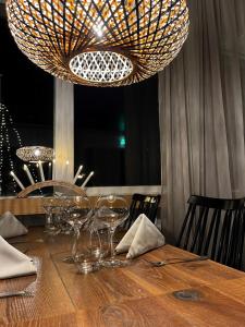 a dining table with wine glasses and a chandelier at Tärnaby Fjällhotell in Tärnaby