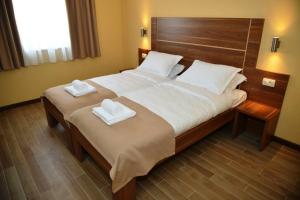 Een bed of bedden in een kamer bij Hotel Pax Cordis