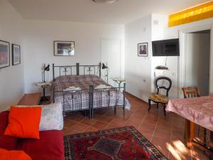 a living room with a bed and a couch at Tra Gli Ulivi in Pietra Ligure
