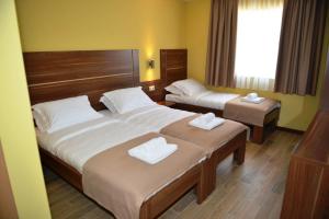 Ліжко або ліжка в номері Hotel Pax Cordis