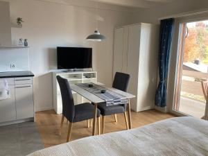 a kitchen with a table and chairs in a room at Studio Bergblick in Eschenbach