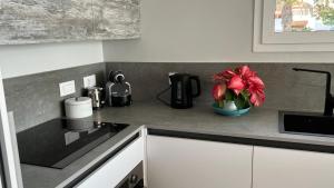 a kitchen counter with a flower in a vase on it at Boutique studio, sea views of Las Vistas and free wifi in Playa de las Americas