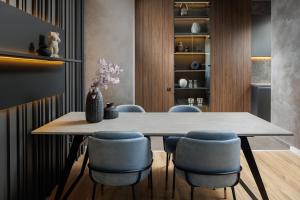 a dining room with a table and chairs at Mandala A Designer Penthouse with Free Private Parking, near Mall Coresi in Braşov