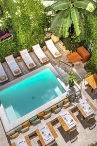 an overhead view of a swimming pool with chairs and a table at Casa Nostra Boutique Hotel & Spa in Palermo