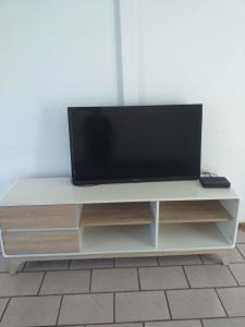 a flat screen tv sitting on a white entertainment center at Windsor Place 6 in Uvongo Beach