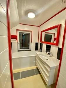 a bathroom with a white sink and a bath tub at Homestead - Ukmergė area 