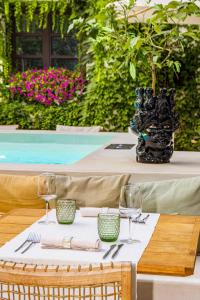 a table with a white table cloth and wine glasses at Casa Nostra Boutique Hotel & Spa in Palermo