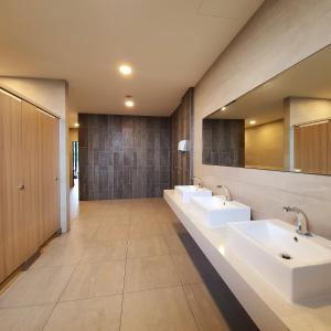 a bathroom with two sinks and two mirrors at The Glass Homestay Putrajaya in Putrajaya