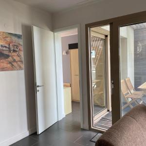 a living room with a sliding glass door with a mirror at YooBulgaria-Obzor SP apartments in Obzor