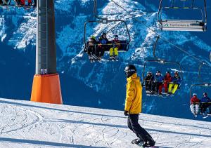 a person on a snowboard in front of a ski lift at FEWO Gabi Haus Pacher in Sankt Peter am Kammersberg