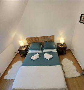 a bedroom with a large bed with two pillows at Sarlat 4 Life in Sarlat-la-Canéda