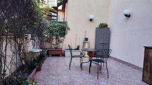 a patio with chairs and a table in a courtyard at Via Arriano 11 in Rome