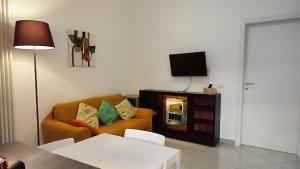 a living room with a couch and a television at Via Arriano 11 in Rome