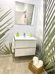 a bathroom with a white sink and a mirror at Loft Sol y Luna en Las Palmas de Gran Canaria in Las Palmas de Gran Canaria