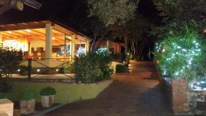 a house lit up at night with christmas lights at Cala Blanca Resort in Marina di Camerota