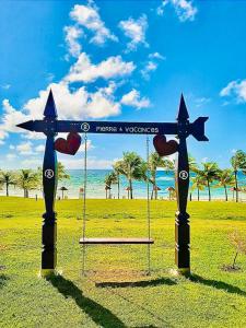 a swing on a beach with stars and hearts at STUDIO CARAMBOLE VUE MER - Piscines - Plages - Village vacances Sainte Anne Guadeloupe in Sainte-Anne