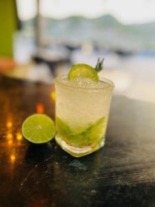 a drink with a lime on a table at Hotel Wanderlust in Santa Marta