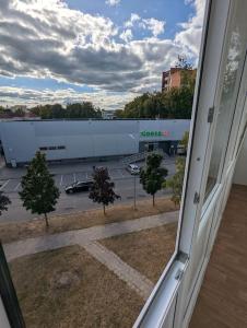 a view of a parking lot from a window at Lovely 2-bedroom flat in the heart of Druskininkai in Druskininkai
