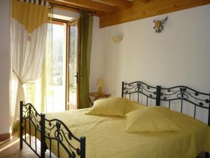 a bedroom with a bed and a window at Chambre d'Hôtes La Bourdasse in Loubens