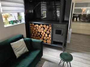 a living room with a couch and a stove with logs at Apartman Kateřinky Liberec in Liberec +6 photos