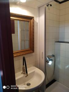 a bathroom with a sink and a shower with a mirror at Casita en Domaio - Moaña in Moaña