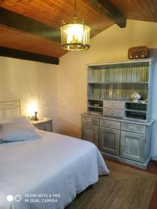 a bedroom with a white bed and a dresser at Casita en Domaio - Moaña in Moaña