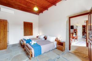 Un dormitorio con una cama y una sala de estar. en Traditional Home Vereniki With Heated Pool - BY APOKORONAS VILLAS, en Gavalochori 32 fotos más