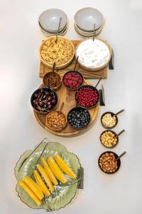 a table topped with bowls of different types of food at Casa Nostra Boutique Hotel & Spa in Palermo