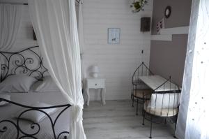 a bedroom with a bed and a table and chairs at Au Coeur Du Bien Etre, chambre d'hôtes avec piscine chauffée et couverte, SPA, sauna, massages in Monteaux