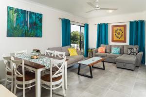 a living room with a couch and a table at Stunning Penthouse at Mcleod Street in Cairns