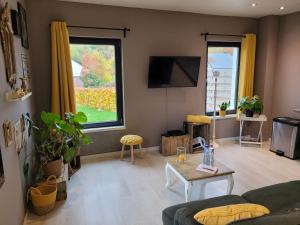 a living room with a couch and a table at My house in Spa