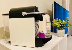 a black and white espresso machine sitting on a counter at Pompidou ROOM PARIS CENTRE in Paris