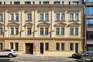 un gran edificio con coches estacionados frente a él en Stylish Apartment in Smíchov by Prague Days, en Praga