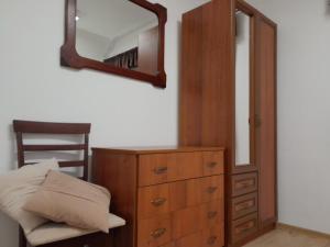 a bedroom with a dresser and a mirror on a wall at Papp Vendégház in Balatonederics