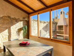 a table in a room with a large window at Villa Lucia in Castroserna de Abajo