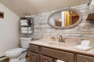 a bathroom with a sink and a mirror at Sleepy Hollow 5BR Cabin - National Park 7 Min, Hot Tub, Fire Pit, Sleeps 12 in Luray