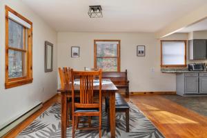 a dining room with a table and chairs at Sleepy Hollow 5BR Cabin - National Park 7 Min, Hot Tub, Fire Pit, Sleeps 12 in Luray