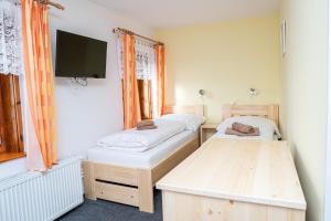 Posteľ alebo postele v izbe v ubytovaní Horský hotel Paprsek