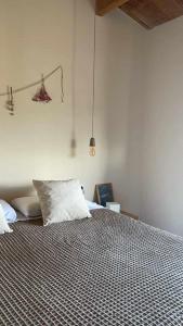 a bedroom with a large bed with white pillows at Casa Diana C in Girona