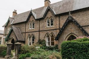 a large brick building with windows and a roof at HIGH SAINT COTTAGE - Stunning 3 Bed Accommodation located in Ripon, North Yorkshire in Ripon