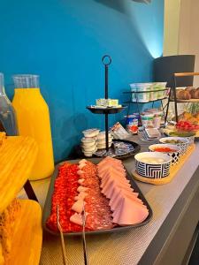 a table with a tray of food with meat and cheese at Bed & Breakfast Donji Grad in Zagreb