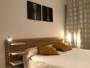 a bedroom with a bed with two pillows on it at Lungotevere Bed&Bike in Rome
